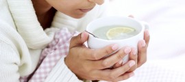 Woman Holding Cup of Water and Lemon