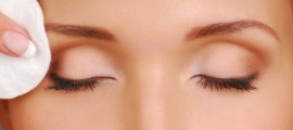 Сleaning woman face with cotton pads. Cosmetic treatment.